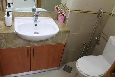 a bathroom with a sink and a toilet at Newly furnished One Bedroom Apartment next to Metro & Beach in Marina Residence in Dubai