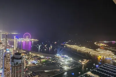 a view of a city at night with a harbor at Frank Porter - Princess Tower in Dubai