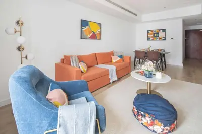 a living room with a couch and a table at Frank Porter - Princess Tower in Dubai