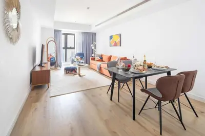 a living room with a table and a couch at Frank Porter - Princess Tower in Dubai