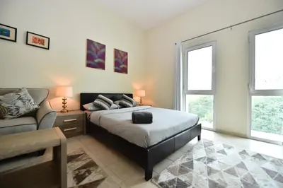 a bedroom with a bed and a couch at Luxury Escapes - Stylish Studio Vacation Home near Metro - MOG189 DG in Dubai