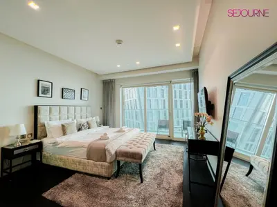 a bedroom with a large bed and a large window at DH58 - High end 1BR, Palm views in Damac Heights tower in Dubai