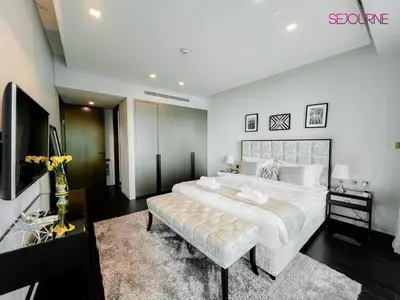 a large bedroom with a large bed and a couch at DH58 - High end 1BR, Palm views in Damac Heights tower in Dubai