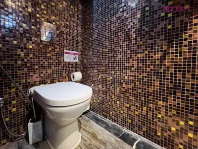 a bathroom with a toilet in a tiled wall at DH58 - High end 1BR, Palm views in Damac Heights tower in Dubai