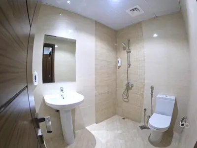 a bathroom with a sink and a toilet and a shower at Karama Star Residence (Home Stay) in Dubai