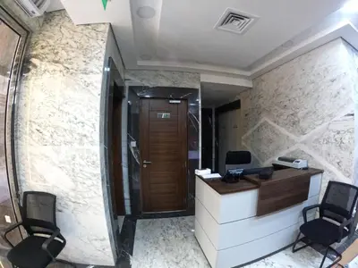 an office with a reception desk and two chairs at Karama Star Residence (Home Stay) in Dubai