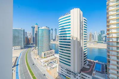a view of a city with tall buildings and a river at Stylish Waterfront Apartment With Views on Canal in Dubai