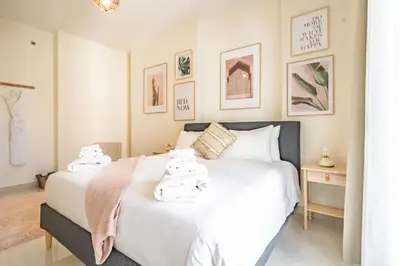 a bedroom with two beds with towels on them at Stylish Waterfront Apartment With Views on Canal in Dubai