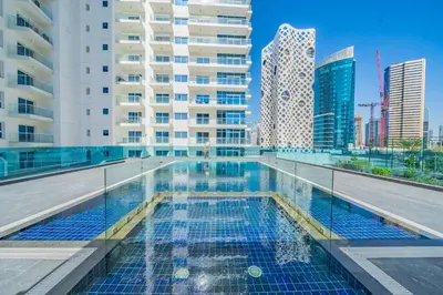 a swimming pool in a city with tall buildings at Stylish Waterfront Apartment With Views on Canal in Dubai
