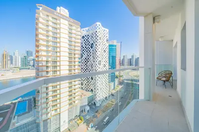 an apartment balcony with a view of a city at Stylish Waterfront Apartment With Views on Canal in Dubai