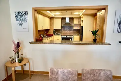 a large kitchen with a table and chairs in it at Luxury Apartment Palm Jumeirah in Dubai