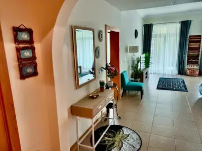 a living room with a table and a mirror at Luxury Apartment Palm Jumeirah in Dubai