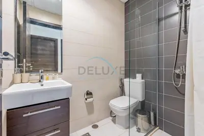 a bathroom with a toilet and a sink and a shower at Furnished 3-Bedroom Townhouse, Just Minutes Drive from Al Marmoom Heritage Village and Popular Dubai Attractions, Albizia, Damac Hills 2 by Deluxe Holiday Homes in Dubai