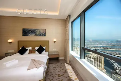 a hotel room with a bed and a large window at The Palm Tower, Nakheel Mall, Palm Jumeirah in Dubai