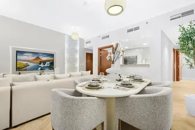 a living room with a white couch and a table at Luxury 2BR with Skyline and Sea Views, Near Burj Khalifa & Dubai Mall in Dubai
