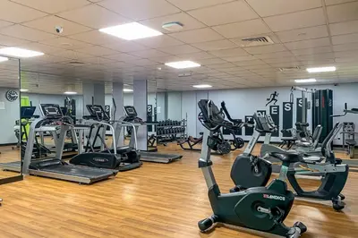 a gym with several treadmills and exercise bikes at Frank Porter - Time Place in Dubai