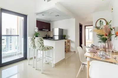 a kitchen and dining room with a table and chairs at Frank Porter - Time Place in Dubai