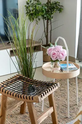 a table with a chair and a table with flowers on it at Frank Porter - Time Place in Dubai