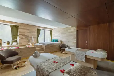 a room with two beds and a mirror at Taj Exotica Resort & Spa, The Palm, Dubai in Dubai