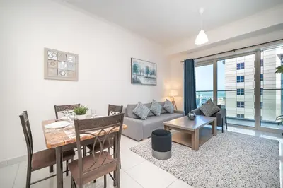 a living room with a couch and a table at Stunning 1BR with Partial Sea View in Damac Heights, Dubai Marina-21AB03 in Dubai