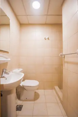 a bathroom with a toilet and a sink at Premium 4BR Apt Pool Palm Beach Club Dubai in Dubai