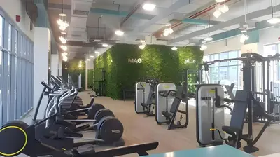 a gym with rows of treadmills and exercise bikes at Budget-friendly 2bd near EXPO with a huge pool in Dubai