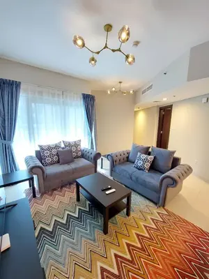 a living room with two couches and a coffee table at Budget-friendly 2bd near EXPO with a huge pool in Dubai
