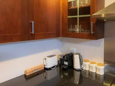 a kitchen counter with a coffee maker on a counter top at Luxury 2BR Burj Khalifa Fountain View with Pool, Gym, and Near Dubai Mall in Dubai