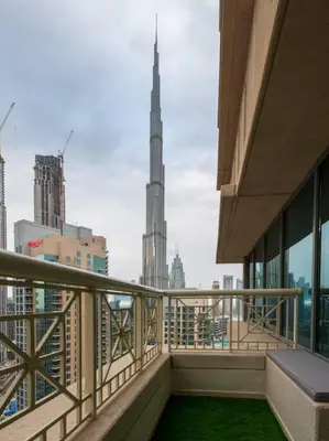 a balcony with a view of the burj khalifa at Luxury 2BR Burj Khalifa Fountain View with Pool, Gym, and Near Dubai Mall in Dubai