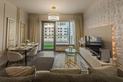 a living room with a couch and a table at Luxury 2BR Burj Khalifa Fountain View with Pool, Gym, and Near Dubai Mall in Dubai