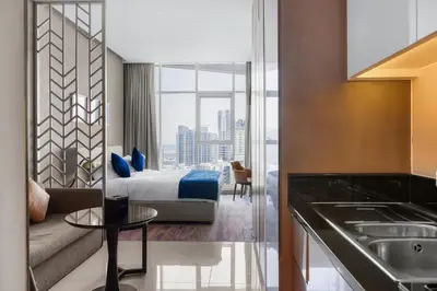 a hotel room with a bed and a living room at Luxury Aparthotel Prive in Dubai