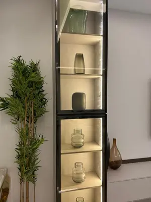 a black shelf with dishes and vases on it at USMANS 4BDRM JBR Sadaf Next to Ritz Carlton Walk Daily Housekeeping JBR in Dubai