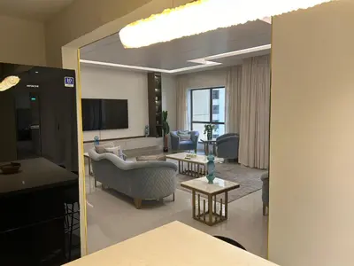 a living room with a couch and a tv at USMANS 4BDRM JBR Sadaf Next to Ritz Carlton Walk Daily Housekeeping JBR in Dubai
