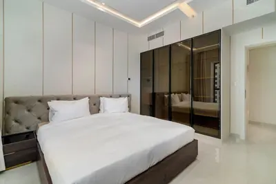 a bedroom with a large bed and a large mirror at USMANS 4BDRM JBR Sadaf Next to Ritz Carlton Walk Daily Housekeeping JBR in Dubai
