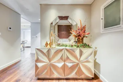 a living room with a large mirror on the wall at Luxurious 3 Bedroom Apartment in Boulevard Point, Connected to Dubai Mall in Dubai