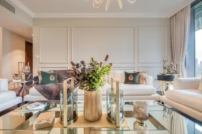 a living room with couches and a glass table at Luxurious 3 Bedroom Apartment in Boulevard Point, Connected to Dubai Mall in Dubai