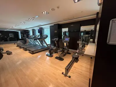 a gym with a bunch of exercise equipment in it at Walk to Burj Khalifa from this 2BR with Skyline Balcony View in Dubai