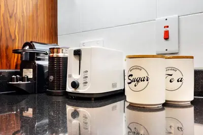 two coffee cups sitting on top of a counter at Walk to Burj Khalifa from this 2BR with Skyline Balcony View in Dubai