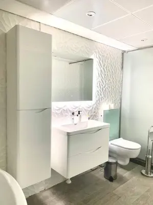 a white bathroom with a sink and a toilet at Luxury 2BR Walk to Burj Khalifa and Dubai Mall with Pool and Gym in Dubai