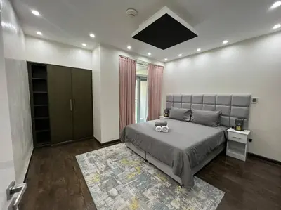 a bedroom with a large bed and a rug at Luxury 2BR Walk to Burj Khalifa and Dubai Mall with Pool and Gym in Dubai