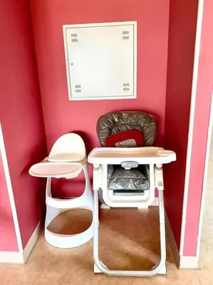 a pink room with a table and a chair at Luxury 2BR Walk to Burj Khalifa and Dubai Mall with Pool and Gym in Dubai