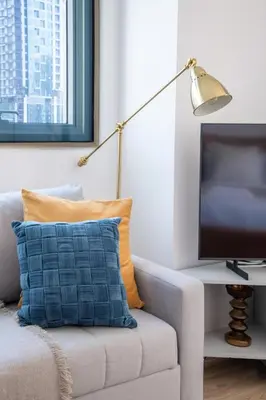 a living room with a couch and a television at Frank Porter - Yacht Bay in Dubai