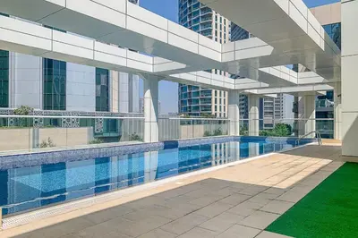 a large building with a swimming pool in front of it at Frank Porter - Mon Reve in Dubai