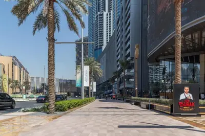 a street in a city with palm trees and buildings at Frank Porter - Mon Reve in Dubai