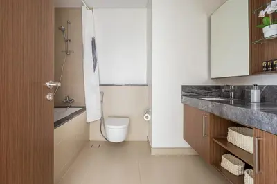 a bathroom with a toilet and a sink at Frank Porter - 5242 EMAAR Tower in Dubai