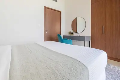 a bedroom with a bed and a desk and a mirror at Frank Porter - 5242 EMAAR Tower in Dubai