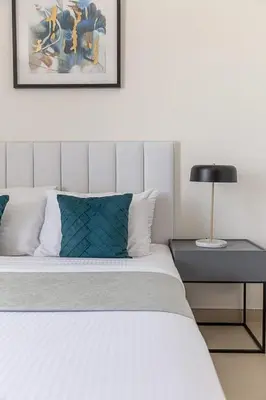 a bedroom with a bed and a lamp on a table at Frank Porter - 5242 EMAAR Tower in Dubai