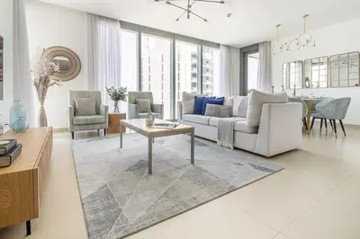 a living room with a couch and a table at Frank Porter - 5242 EMAAR Tower in Dubai