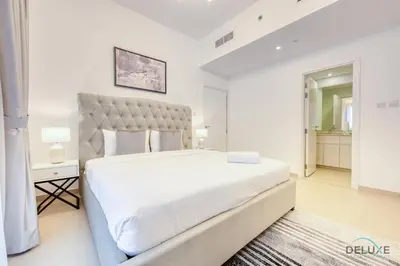 a white bedroom with a large bed in a room at Exquisite 2BR at Zahra Breeze Dubailand by Deluxe Holiday Homes in Dubai