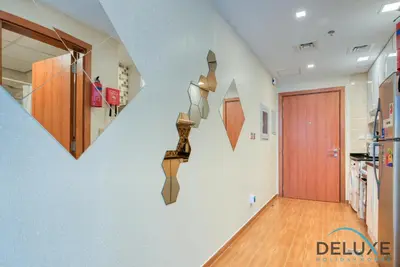 a hallway with a door and a room with a hallway at Short Distance from Global Village & Other Major Attractions Studio Unit, Al Jawhara Tower, Jumeirah Village Triangle by Deluxe Holiday Homes in Dubai